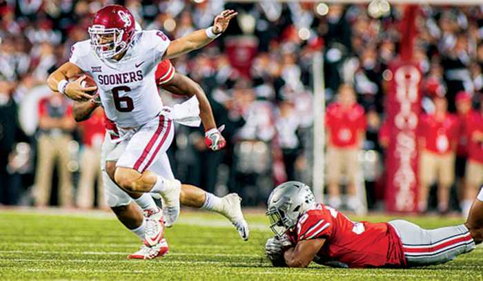 Oklahoma Sooners quarterback Baker Mayfield (6) runs out of the tackle by Ohio State Buckeyes linebacker Malik Harrison (39) in the first half of the game at Ohio Stadium.